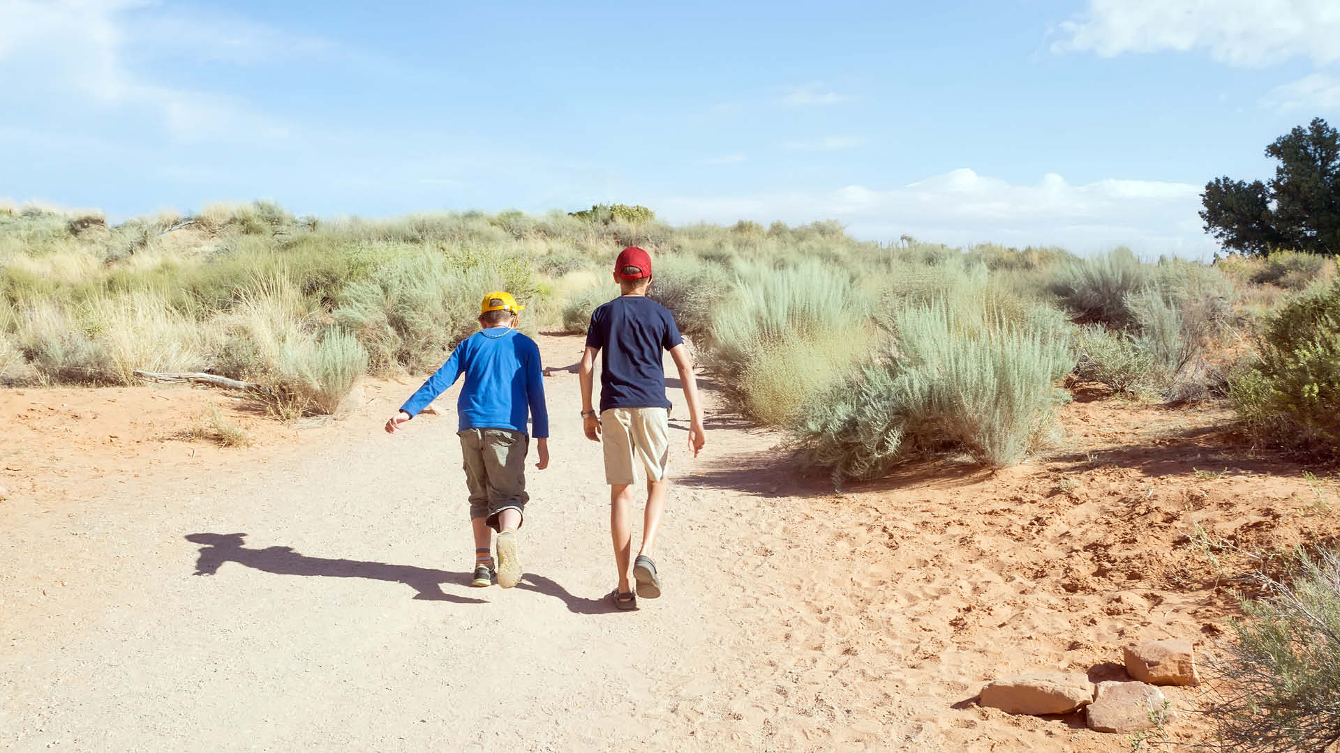 Two children hiking in the desert